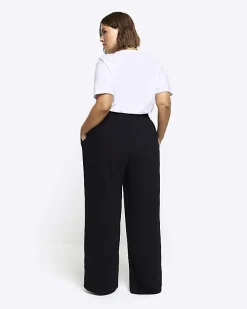 Black pleated wide leg trousers