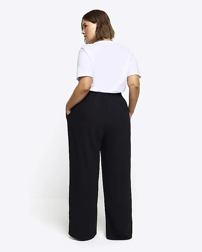 Black pleated wide leg trousers
