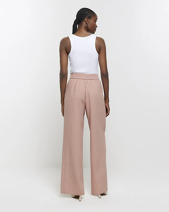 Pink pleated wide leg trousers